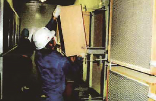 Workers replacing a filter